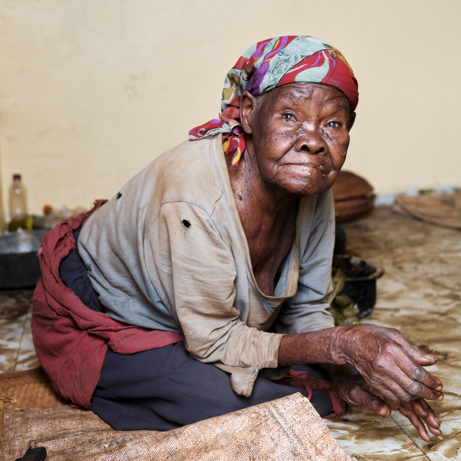 Photo of elderly woman being helped by the Senior Care Program